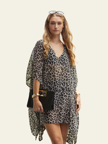 This lightweight animal print cover-up is designed for the beach, offering a relaxed and stylish layer over swimwear. The fabric is soft and breathable, making it ideal for warm weather. The cover-up reaches just above the knees, providing enough coverage while still being breezy and comfortable.