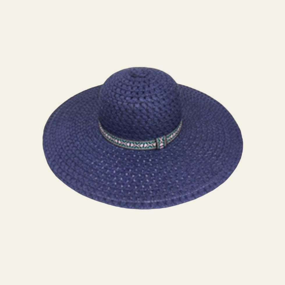 The hat is complemented by a sleek black band adorned with an abstract print adding a unique, artistic touch. The combination of the bold blue with the contrasting black band creates a striking design that stands out while maintaining a stylish, modern aesthetic. Lightweight and comfortable, this hat offers sun protection and adds a pop of color to any outfit.